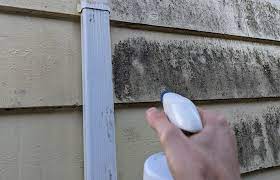 Ultra Cleaning technician washing down an exterior building wall during facade cleaning
