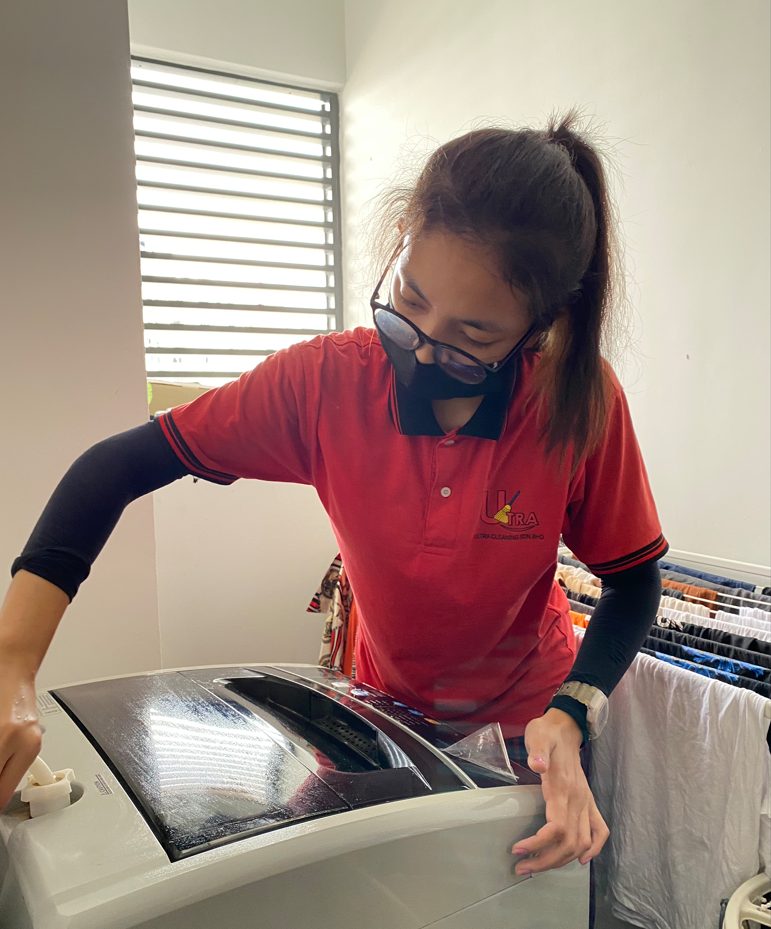 Ultra Cleaning specialist handling laundry